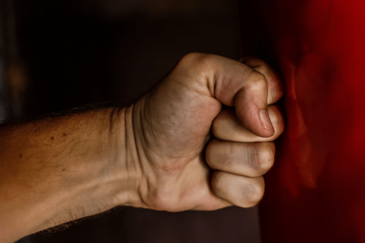 Man hitting fist against the wall