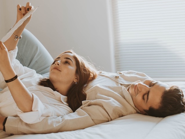 Couple laying on bed