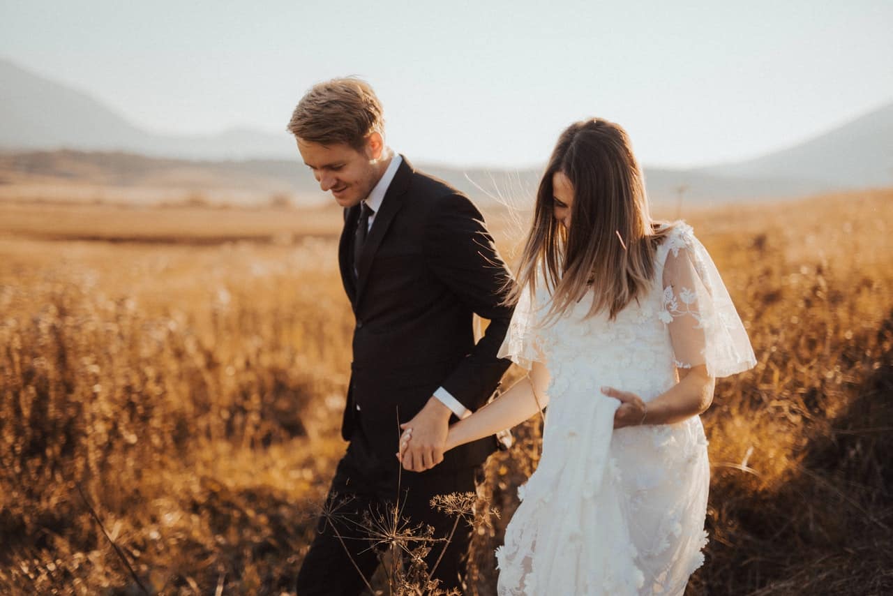 New husband and wife in field